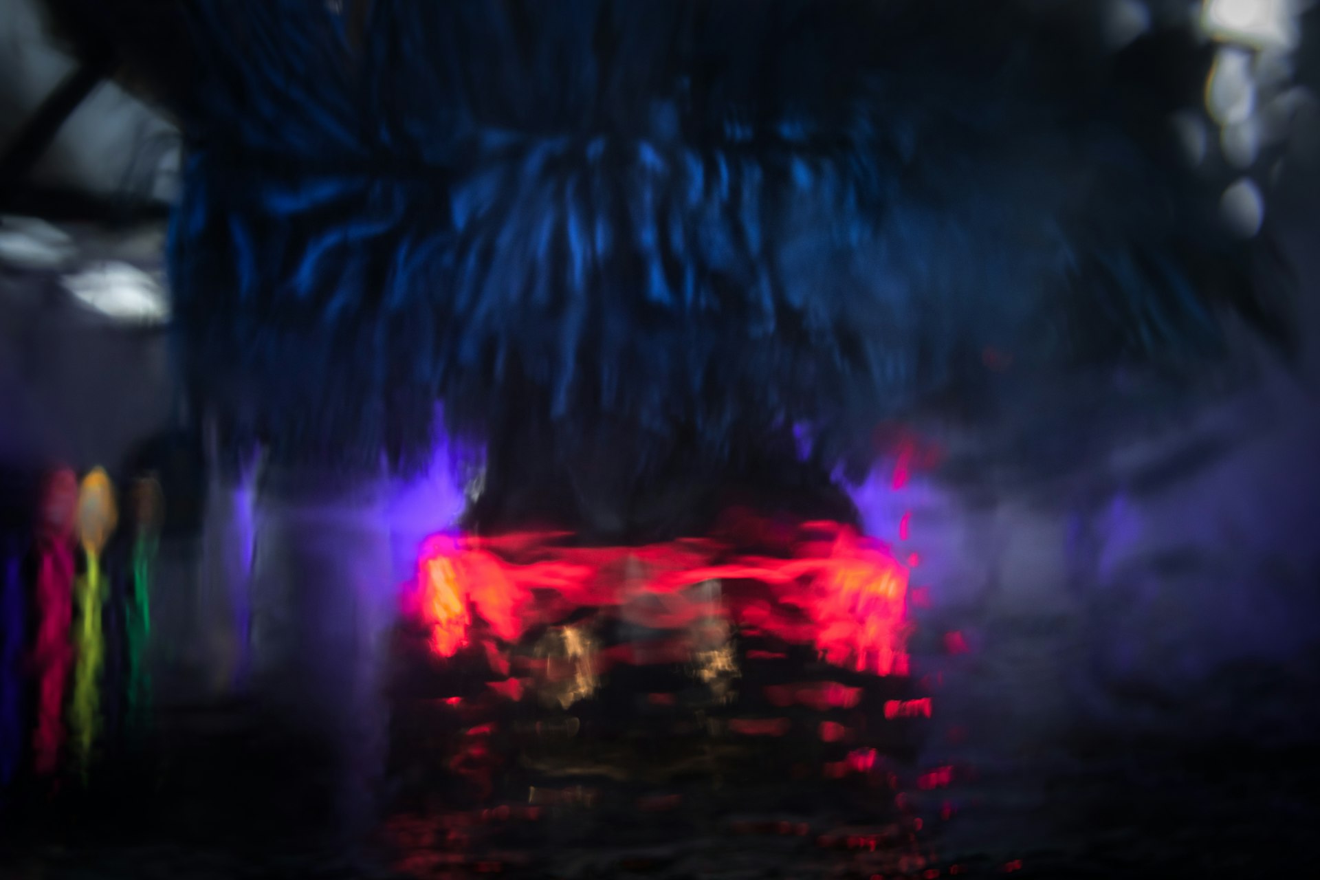 a blurry photo of a car in the rain